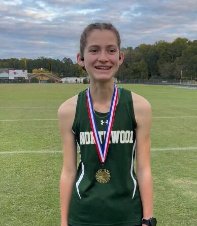 Northwood’s Sydney Gray poses with her first-place medal after the Mid-Carolina 1A/2A Conference cross country championship.